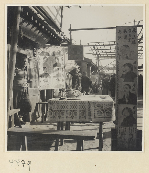 Street doctor's stand showing posters picturing ailments