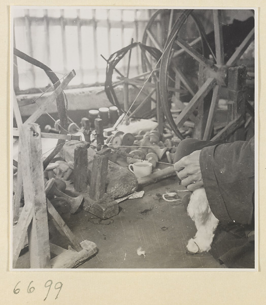 Man spinning cotton in a workshop