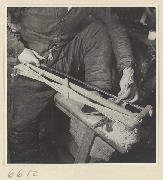 Man sawing a piece of horn in a horn-comb workshop