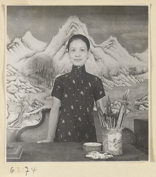 Female artist standing at a work table