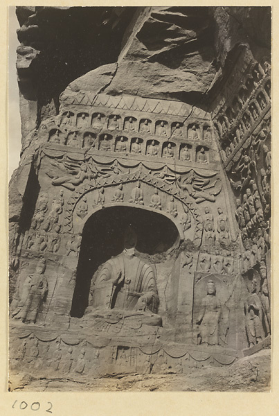 View of a wall at the entrance of a cave showing a Buddha niche