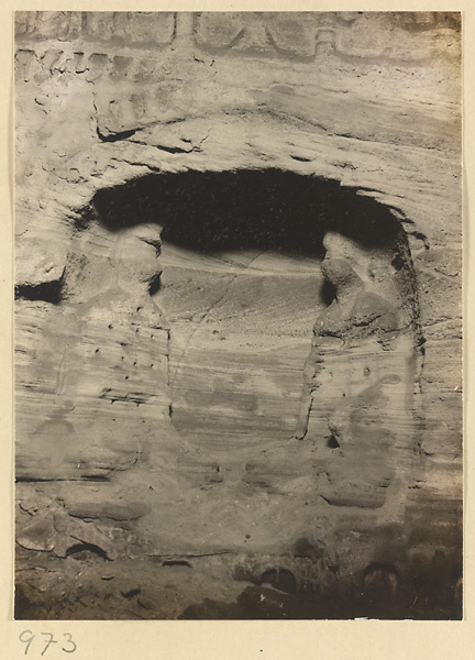 View of a niche with eroded Buddhist reliefs at the Yun'gang Caves