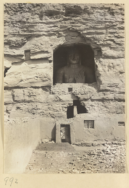 Detail of Wuzhou Cliff at Yun'gang showing a cave entrance with a statue of Buddha