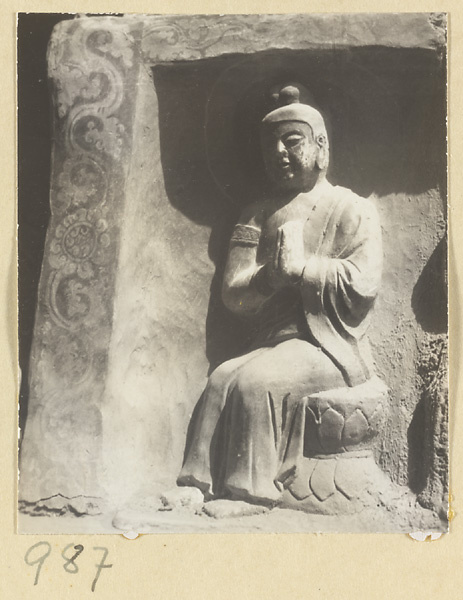 Interior detail of a cave temple at Yun'gang showing a niche with a seated Buddha