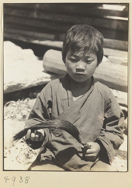 Novice Daoist priest holding a yak-tail fly whisk on Hua Mountain