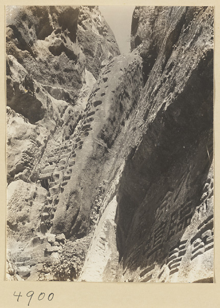 Inscription and steps cut into rock face leading up to North Peak Ridge of Hua Mountain
