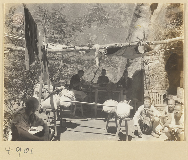 Mat shed rest stop with travelers and porters on the trail up Hua Mountain