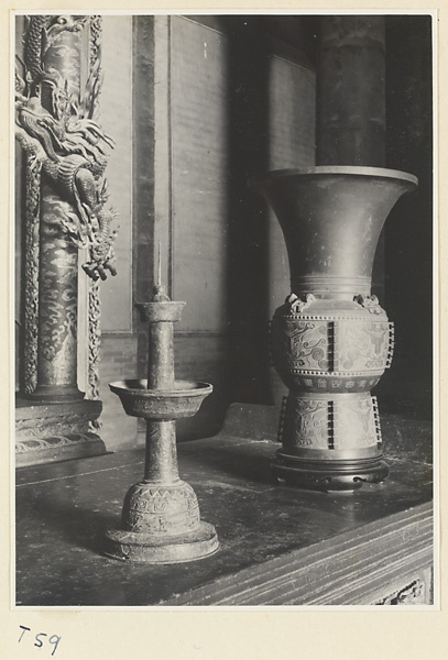 Interior of Da cheng dian showing a candlestick and a vase at the altar of Confucius