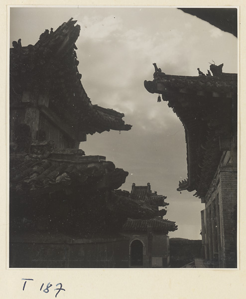 Details of temple buildings on Tai Mountain showing roof ornaments silhouetted against the sky