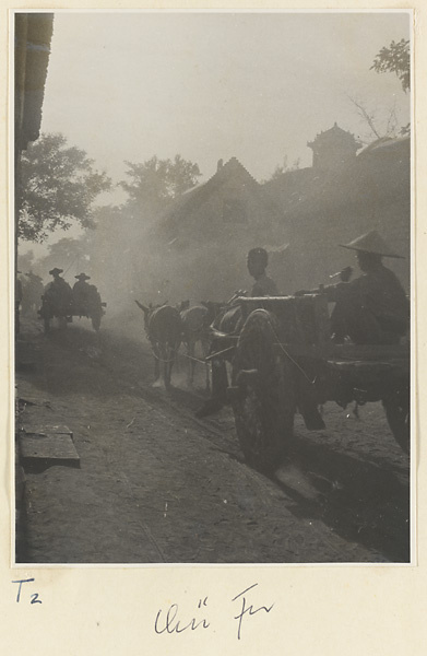 People riding in donkey carts on a street in Qufu