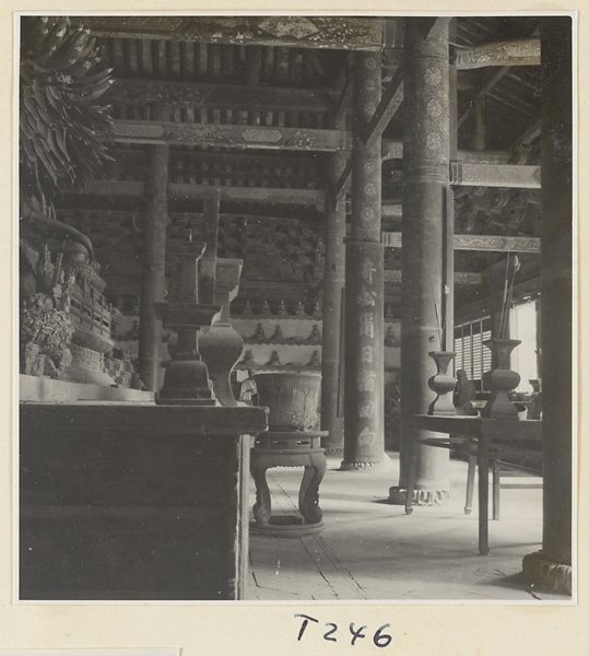 Interior of a temple building at Ling yan si showing an altar and inscribed columns