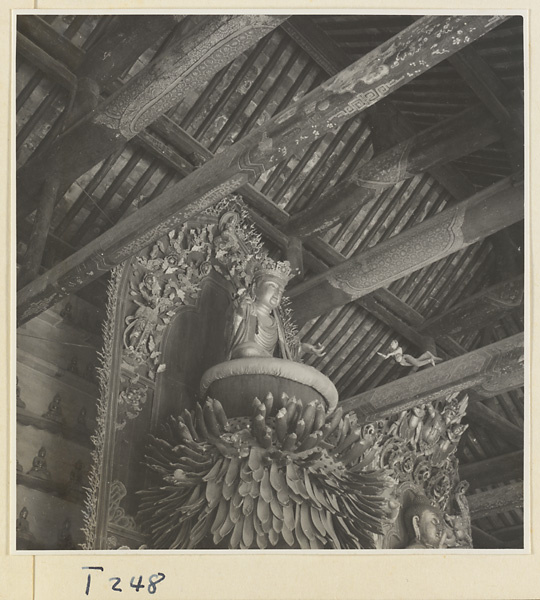 Interior of a temple building at Ling yan si showing a statue of a Bodhisattva on a lotus throne