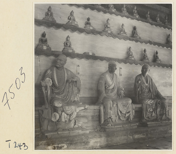 Interior of a temple building at Ling yan si showing statues of Luohans and figurines of Buddhas