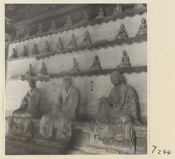 Interior of a temple building at Ling yan si showing statues of Luohans and figurines of Buddhas