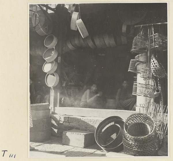 Store front displaying baskets, bamboo steamers, and bird cages for sale in Tai'an