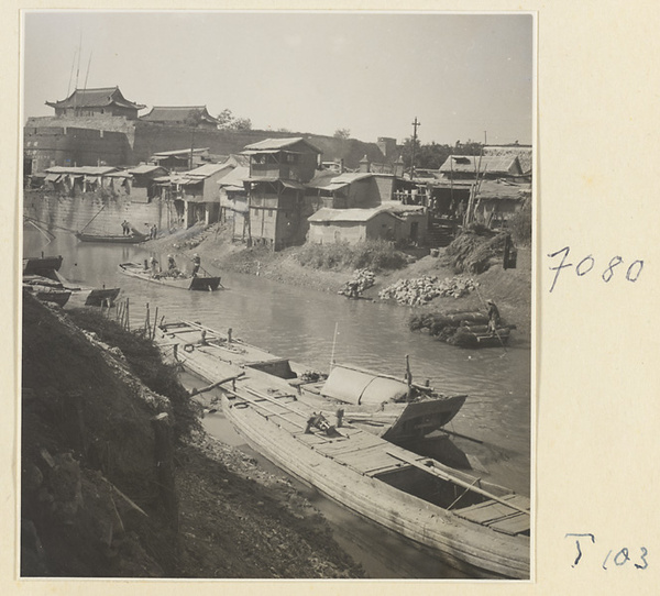 Boats on the river at Tai'an with houses and city walls in the background