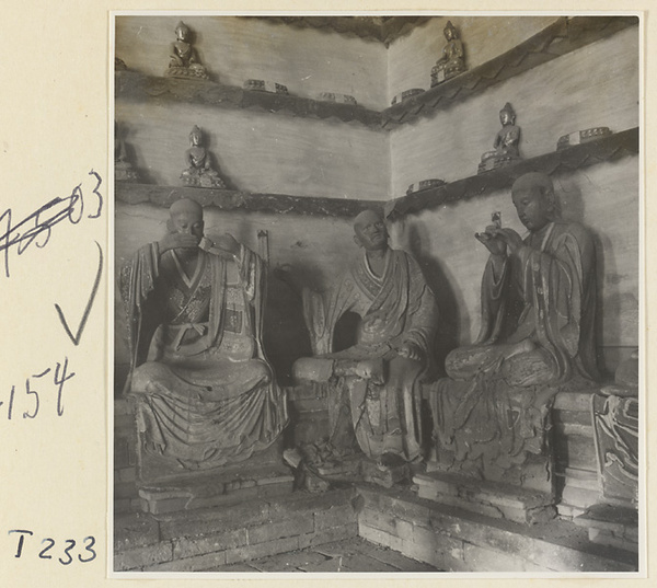 Interior of a temple building at Ling yan si showing statues of Luohans and figurines of Buddhas