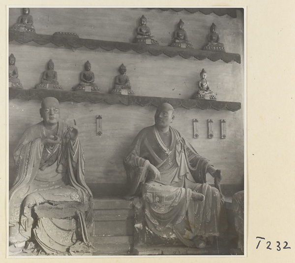 Interior of a temple building at Ling yan si showing statues of Luohans and figurines of Buddhas