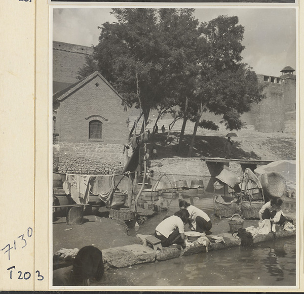 Village women washing clothes in the river at Ji'nan