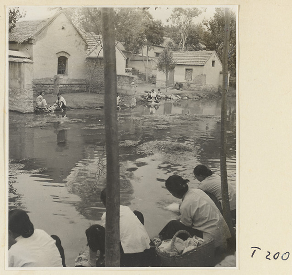 Village women washing clothes in the river at Ji'nan