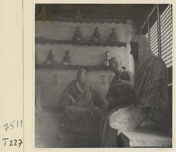 Interior of a temple building at Ling yan si showing statues of Luohans and figurines of Buddhas