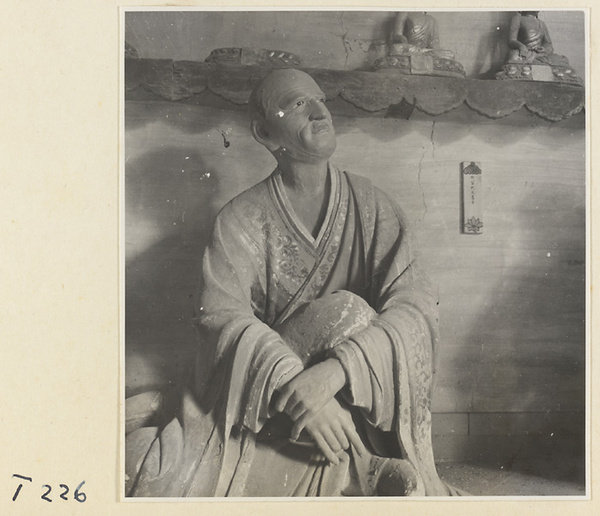 Interior of a temple building at Ling yan si showing a statue of a Luohan