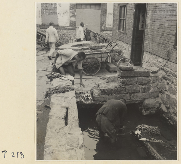 Village men washing vegetables in the river at Ji'nan