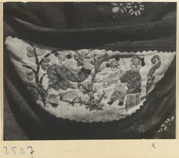Embroidered purse from a village on the Shandong coast with design showing figures and trees