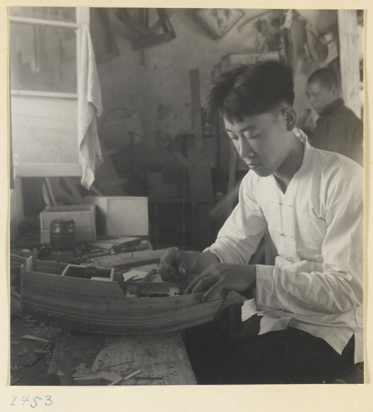 Man making a model of a junk in a workshop in a village on the Shandong coast