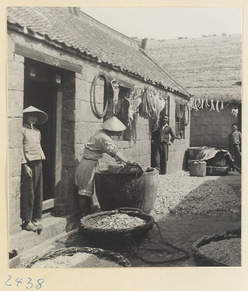 People drying fish in a village on the Shandong coast