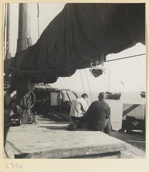 Two men sitting on a junk on the Shandong coast