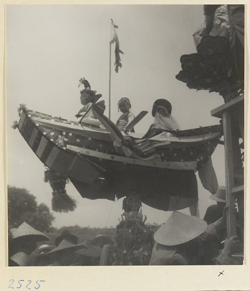 Actors in a boat at a market fair during the Dragon Boat Festival in a village on the Shandong coast