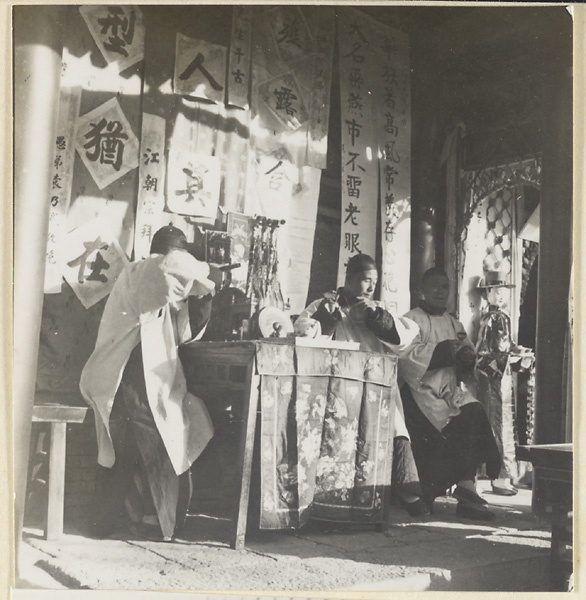 Musicians playing, hanging elegaic scrolls, and paper figure during a funeral