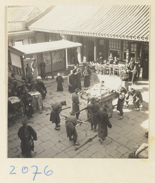 Wedding procession with sedan chair in courtyard