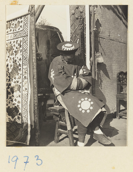 Musician seated next to a drum during a funeral procession