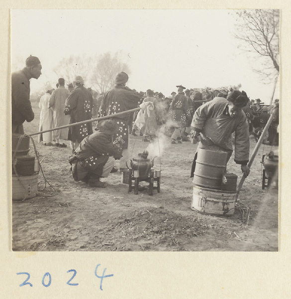 Members of a funeral procession making tea