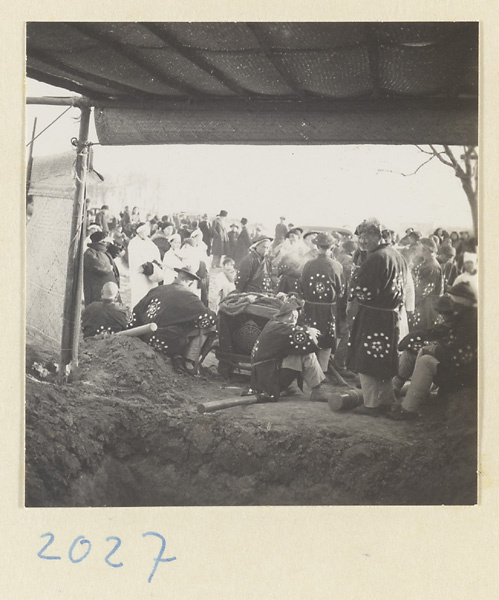 Members of a funeral procession at graveside