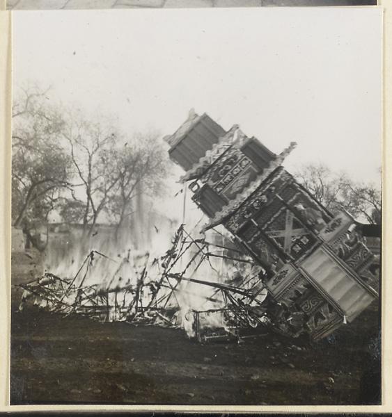 Paper replica of a building burning during funeral service