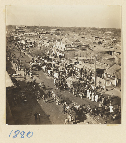 Funeral procession with draped coffin proceeding down a street