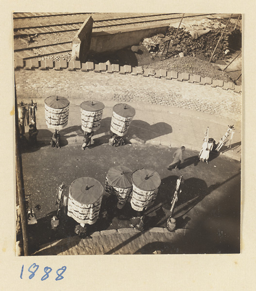 Funeral procession with umbrellas and banners