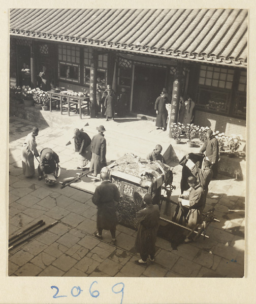 Wedding procession with sedan chair in courtyard