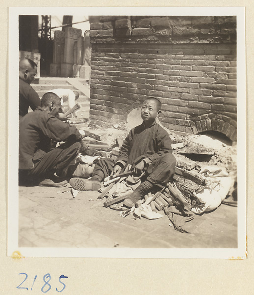 Pilgrims lighting incense beside brick incense burner on Miaofeng Mountain