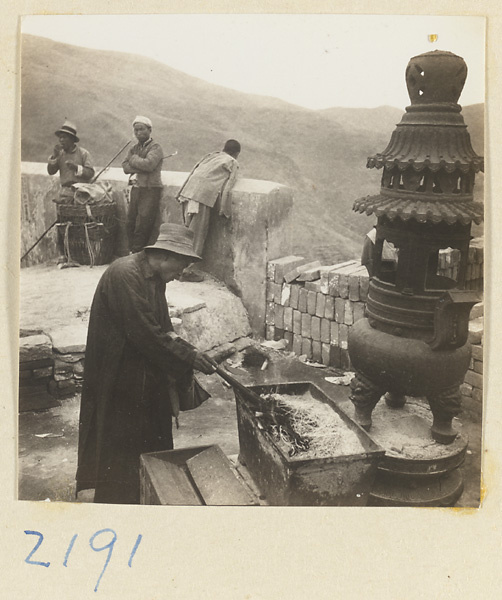 Pilgrims burning incense in metal incense burners on Miaofeng Mountain