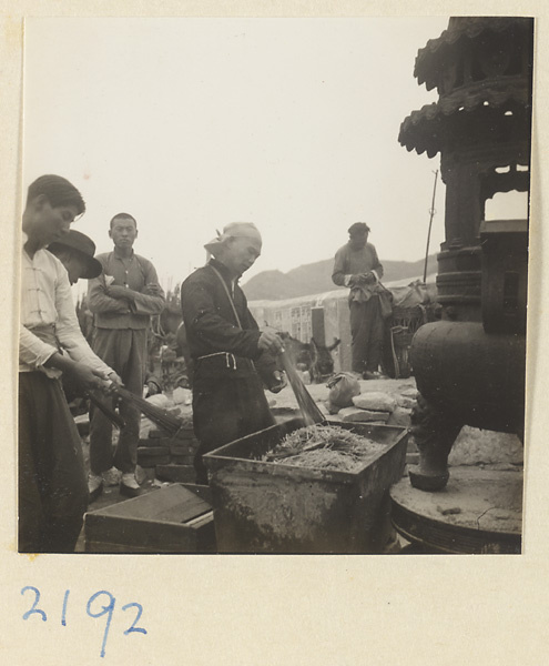 Pilgrims burning incense in metal incense burners on Miaofeng Mountain