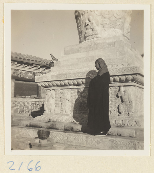 Pilgrim praying next to the stupa-style pagoda on Miaofeng Mountain