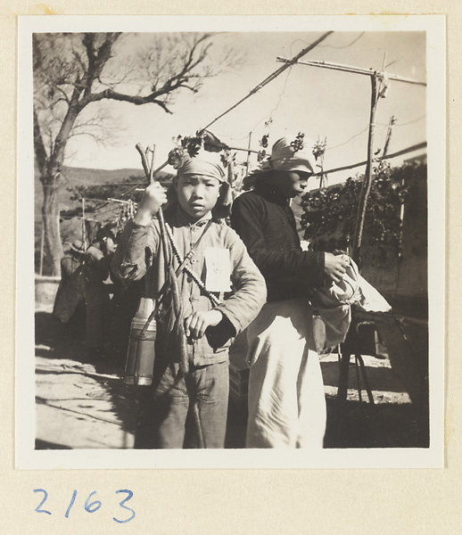 Pilgrims with sourvenir hats and peach-wood walking sticks on Miaofeng Mountain