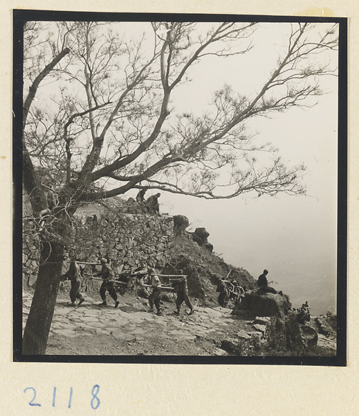 Pilgrim being carried up Miaofeng Mountain in a sedan chair