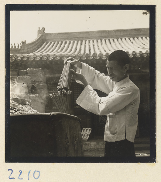 Pilgrim lighting incense on Miaofeng Mountain
