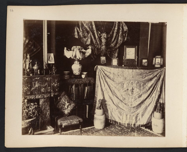Corner of room with photographs, Chinese art objects, and decorative silk hangings, Drew family home, Canton