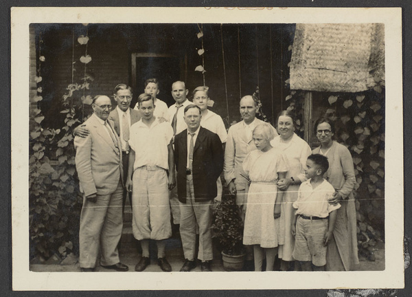 Chengchow, Honan.  The Silva household.  Mr. Anderson, Dr. Zwemer, Holm, Silva, Mr. Tvedt, Schlosser, Mr. Holm, Mr. Schlosser, Schlosser, Mrs. Schlosser, Mrs. Silva & son.